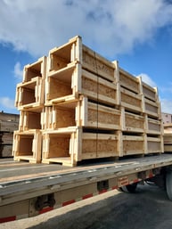 custom wooden packing crates stacked on a flatbed and secured with banding