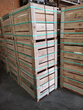 custom wooden packing crates stacked and secured with green banding