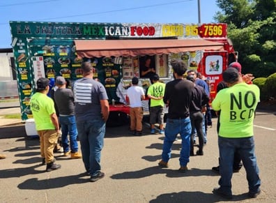 team members line up at the food truck