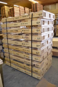 A stack of custom-sized pallets which are slightly longer than a standard-size pallet